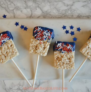 These Patriotic Rice Krispie Bars are a simple and fun treat for summertime BBQ's. Let the kids handle the dessert prep this year. #patriotic #redwhiteblue #bbqdessert #summer #4thofjuly #memorialday #laborday | Dessert Recipe | Snack Recipe | Red White Blue | 4th Of July | Memorial Day | Labor Day | Rice Krispie Treats |